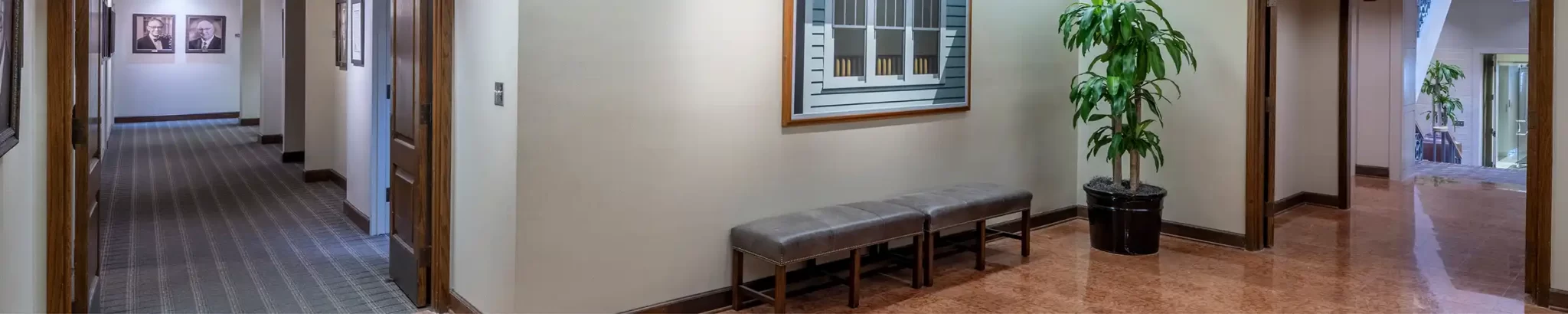 A corridor with framed pictures the wall